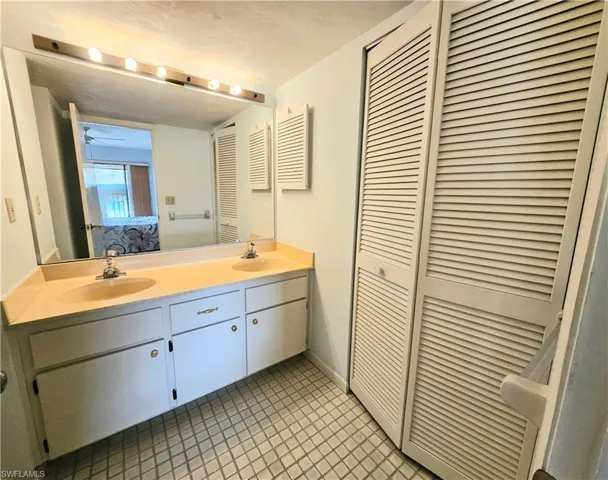 Bathroom with tile patterned floors and vanity