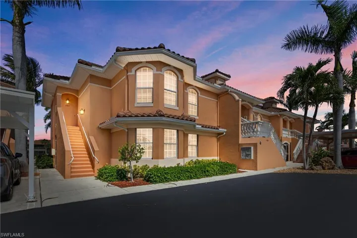 Mediterranean / spanish-style house with stucco siding, stairway, and a tiled roof