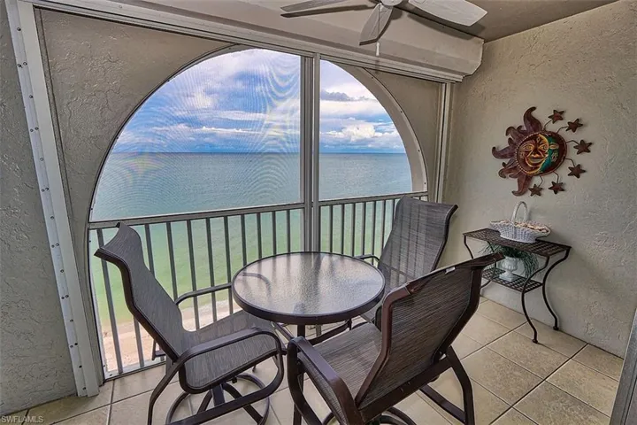 Sunroom / solarium with a water view and healthy amount of natural light