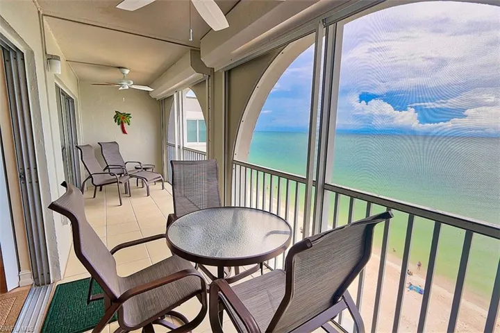 Balcony with a ceiling fan and a water view