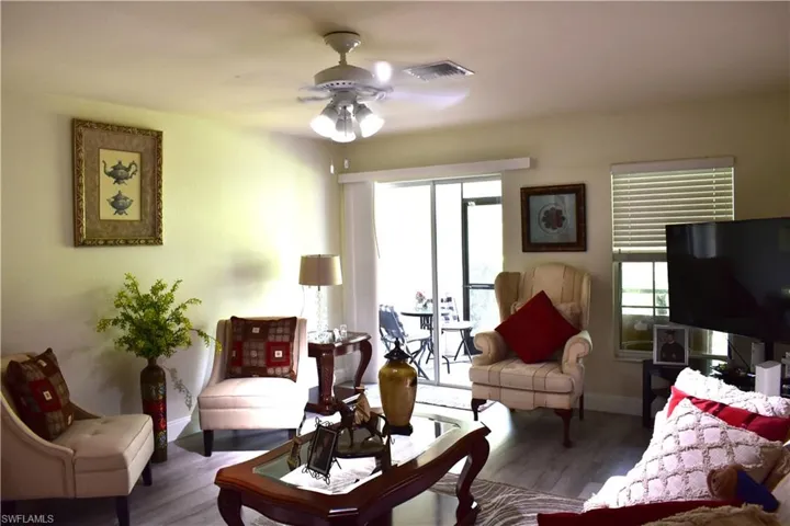 Living room with wood finished floors and a ceiling fan