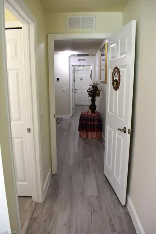 Hallway featuring light wood finished floors