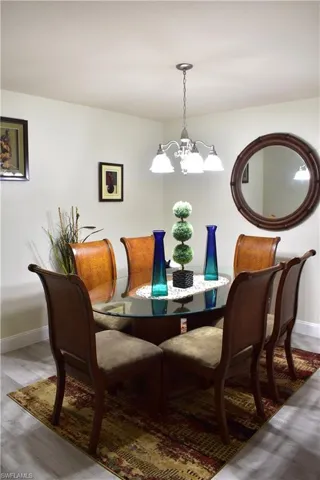 Dining area featuring wood finished floors and a chandelier