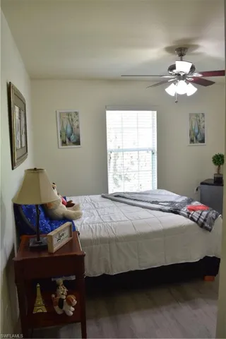 Bedroom featuring wood finished floors and a ceiling fan