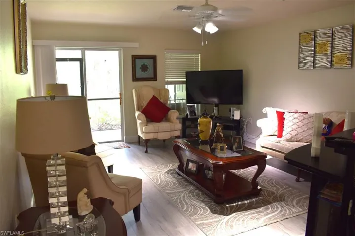 Living area featuring wood finished floors and a ceiling fan