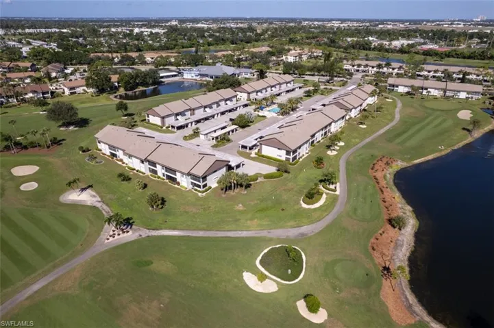 Aerial view of property's location with a local golf course and a nearby body of water
