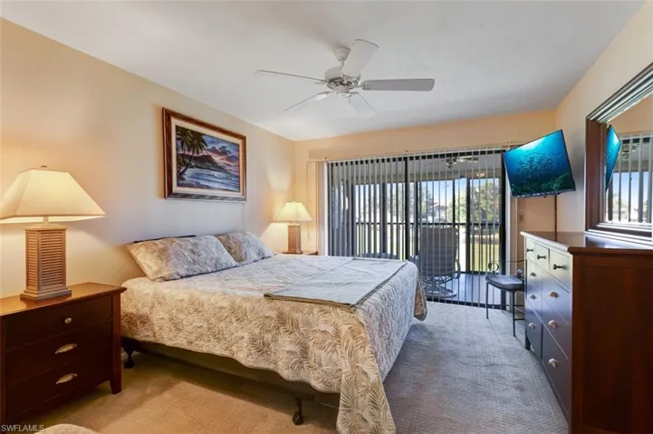 Bedroom featuring light carpet, access to exterior, and ceiling fan