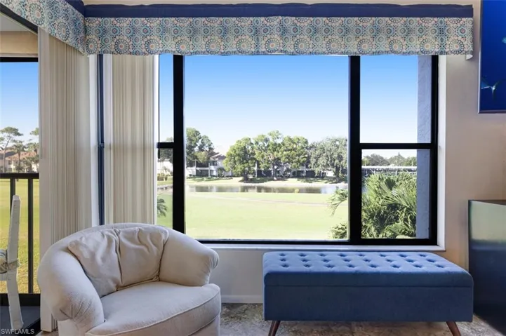Living room featuring healthy amount of natural light and a water view