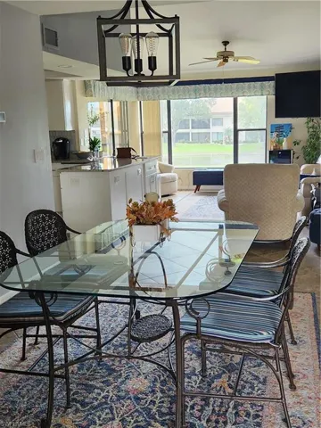Dining room featuring ceiling fan and a chandelier