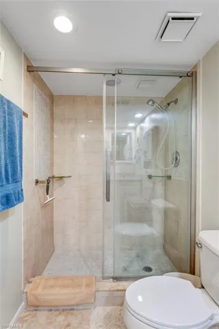 Bathroom with toilet and a stall shower