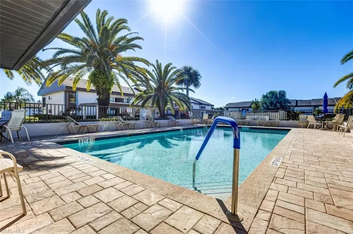 Community pool with a patio