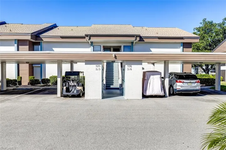View of property with covered parking