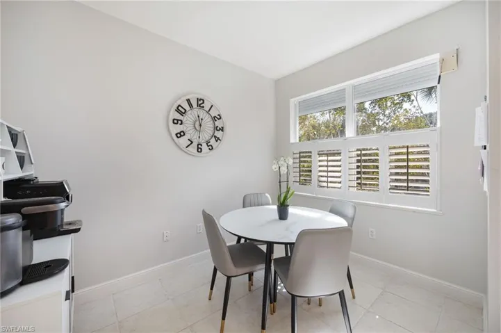 Dining space with baseboards and light tile patterned floors