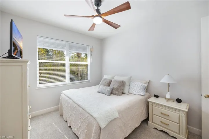 Guest Bedroom ! with a ceiling fan and carpet floors