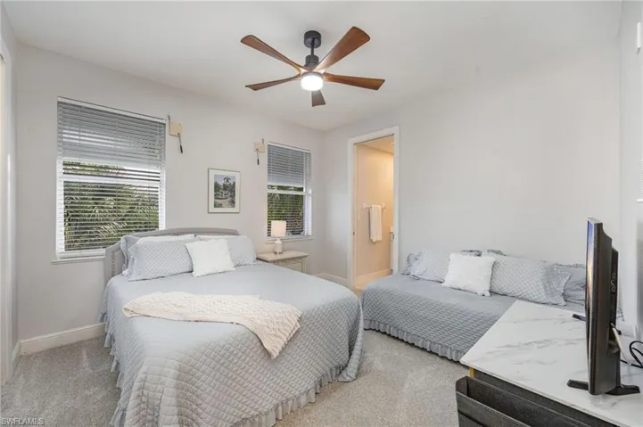 Bedroom featuring light carpet and ceiling fan