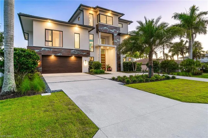 Contemporary home featuring a garage and a front yard