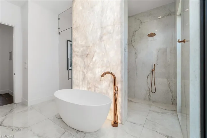Bathroom featuring tile patterned floors and separate shower and tub