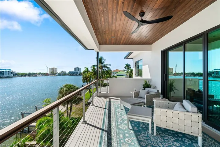 Balcony with ceiling fan and a water view