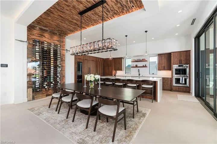 Tiled dining room featuring sink and wood ceiling