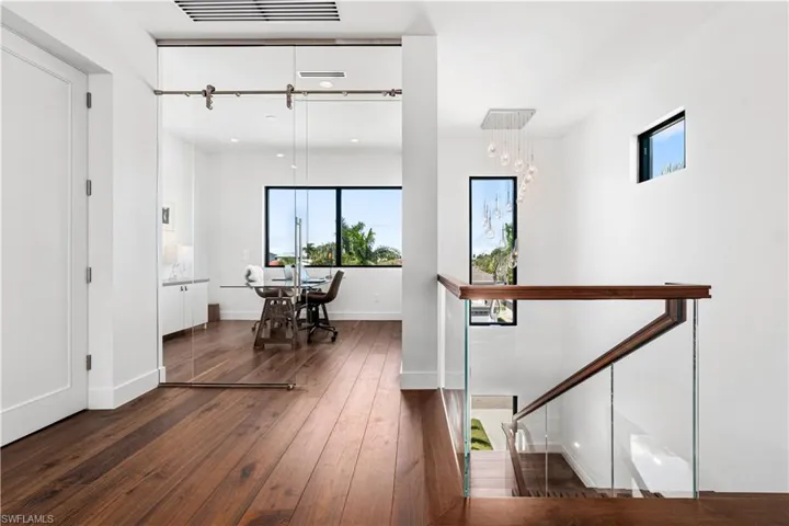 Corridor with dark hardwood / wood-style floors