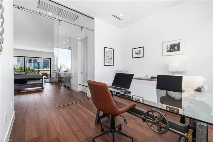 Office space featuring dark hardwood / wood-style flooring