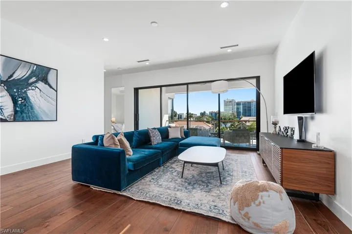 Living room with dark hardwood / wood-style flooring
