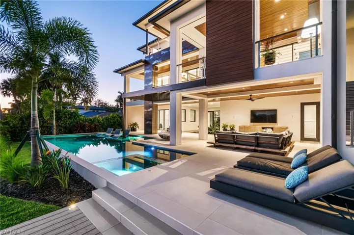 Rear view of house featuring a patio area and an outdoor living space