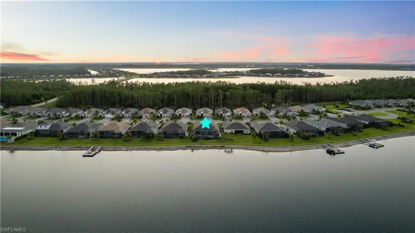 Aerial view at dusk featuring a water view