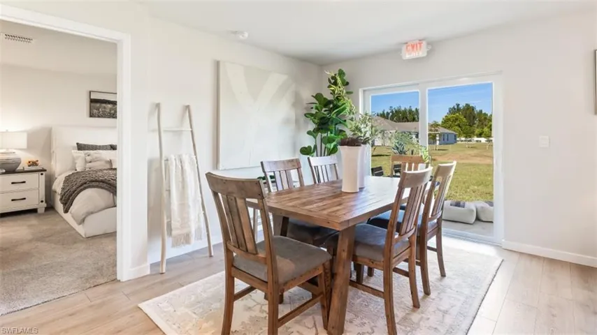 Model home. Dining area with light wood-style floors