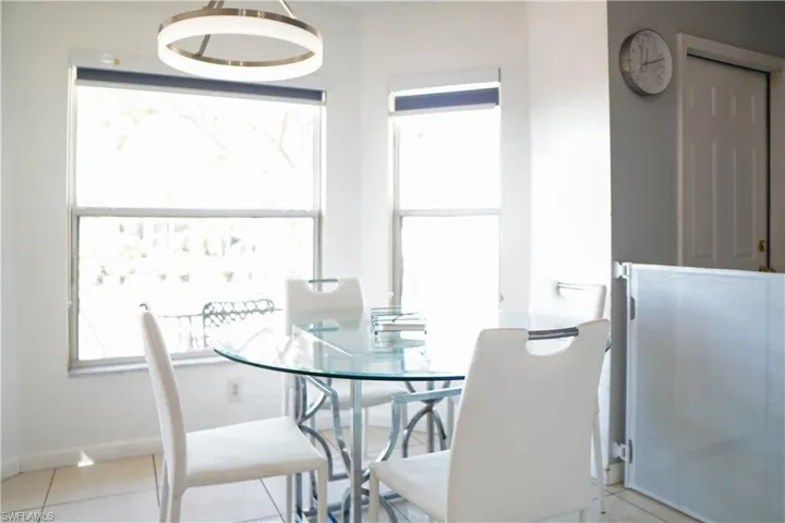 Dining room with light tile patterned flooring and baseboards