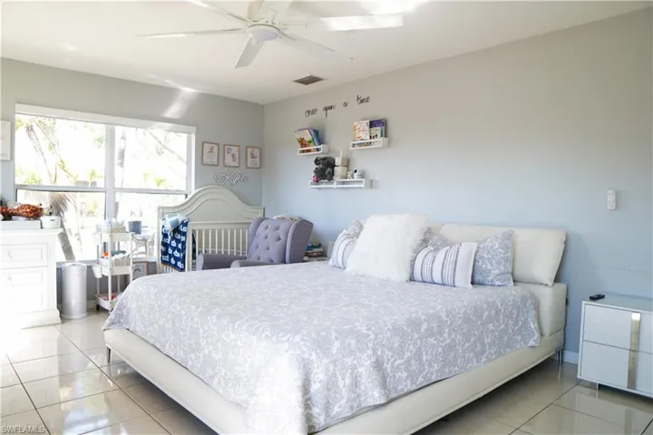 Bedroom with a ceiling fan and light tile patterned floors