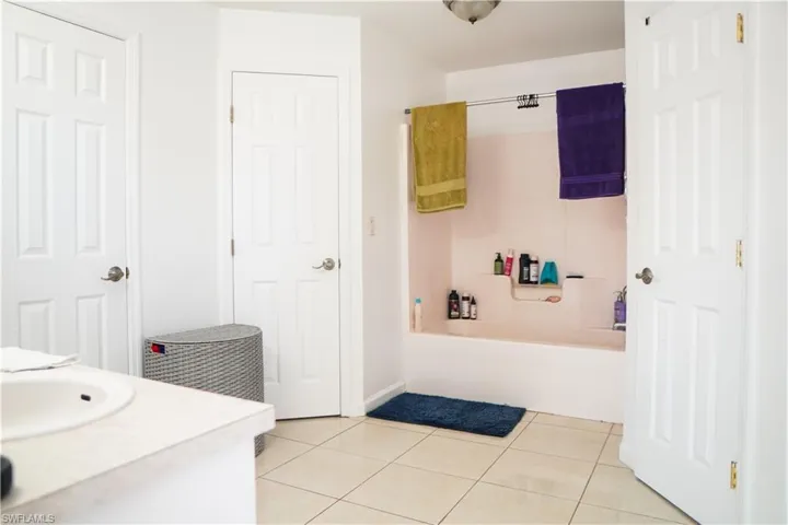 Full bathroom with vanity, light tile patterned flooring, and shower / bathtub combination