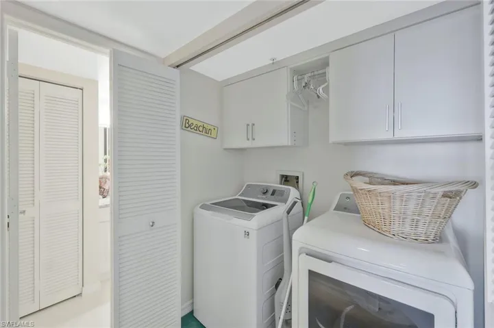 Laundry area featuring cabinet space and washing machine and clothes dryer