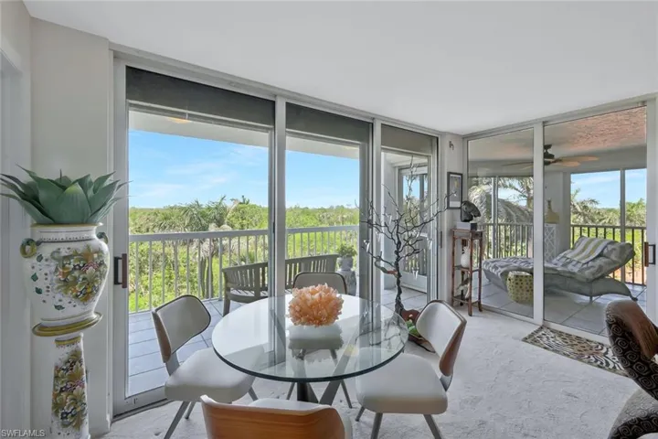 Sunroom / solarium featuring expansive windows and carpet floors