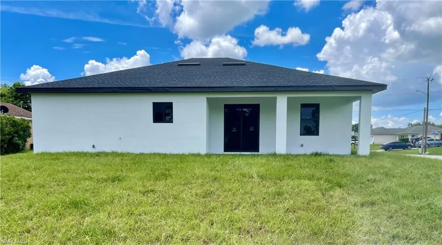 Rear view of property featuring a yard