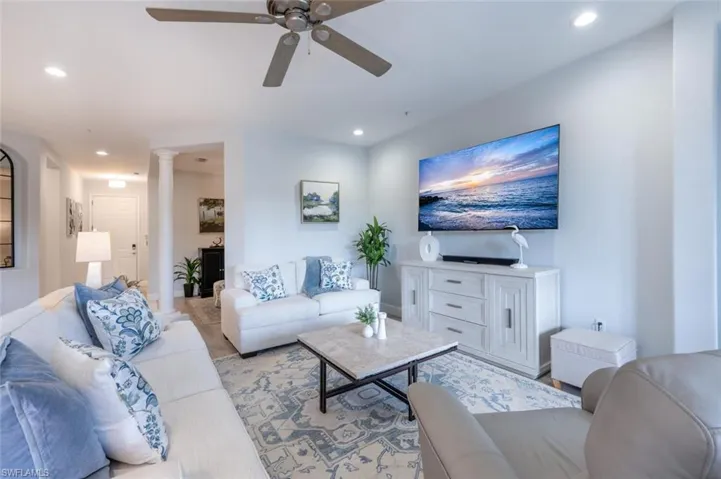 Living room featuring ornate columns, a ceiling fan, and recessed lighting