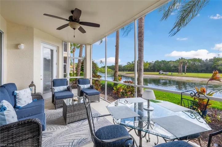 Sunroom / solarium featuring a water view and ceiling fan