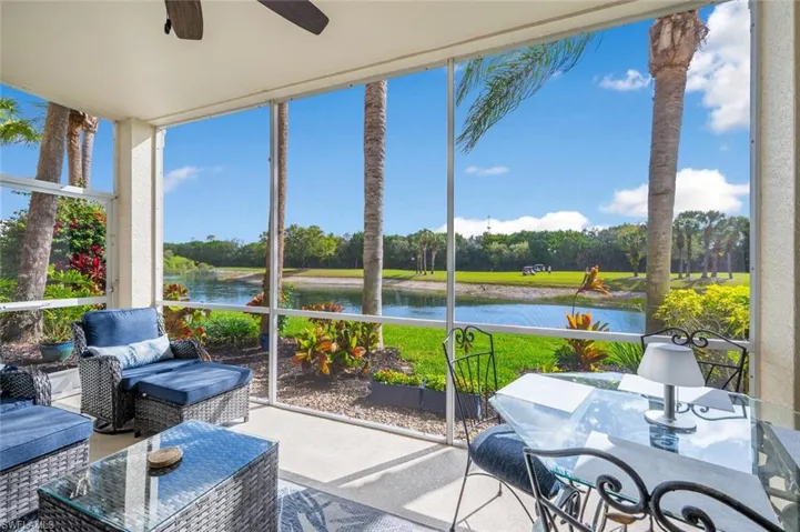 Sunroom with a water view and ceiling fan