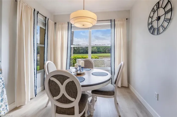 Dining space featuring light wood-style floors and baseboards