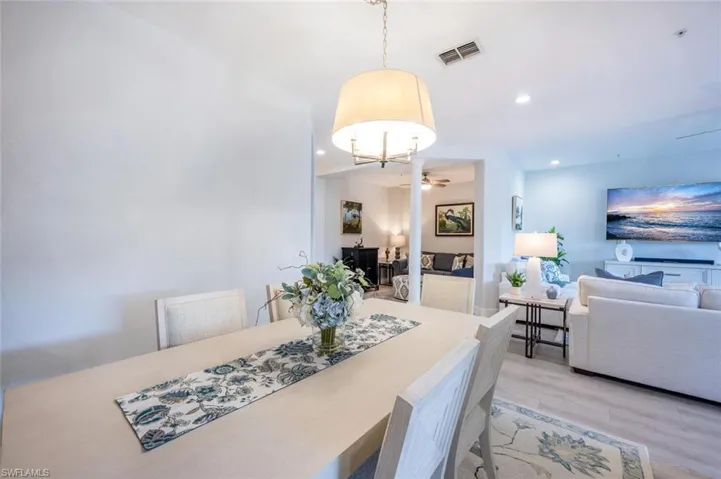 Dining room with ceiling fan, light wood-style flooring, visible vents, and recessed lighting