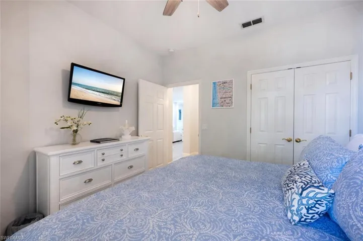 Bedroom featuring a closet, visible vents, and ceiling fan