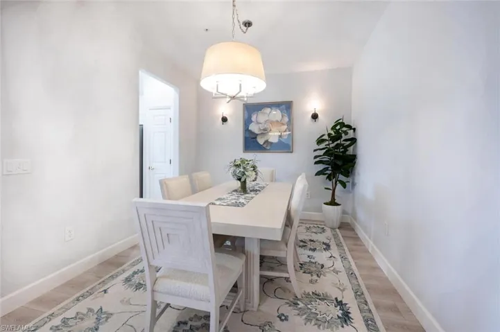 Dining room featuring light wood finished floors and baseboards