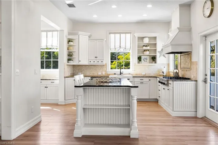 Amazing kitchen has a stunning island, gas cooktop, lots of custom cabinetry, and natural light!