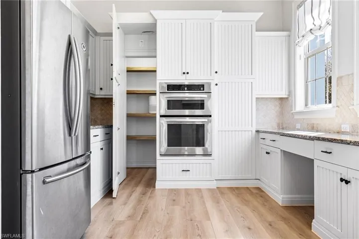 There is a hidden cabinet on the left that opens to a walk in pantry.