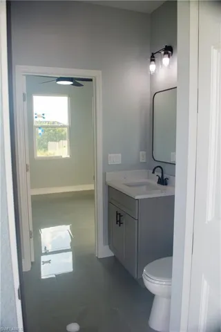 Bathroom featuring tile patterned flooring, vanity, and toilet