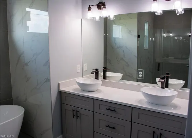 Bathroom with vanity and plus walk in shower