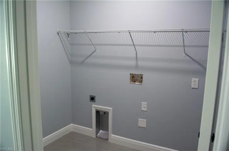 Laundry room with tile patterned flooring, electric dryer hookup, and hookup for a washing machine