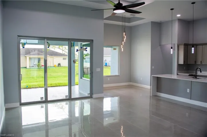 Entryway featuring ceiling fan and sink