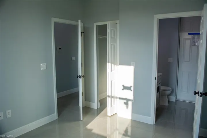 Bathroom featuring toilet and tile patterned flooring