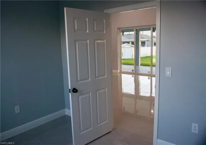 Doorway to outside featuring tile patterned floors